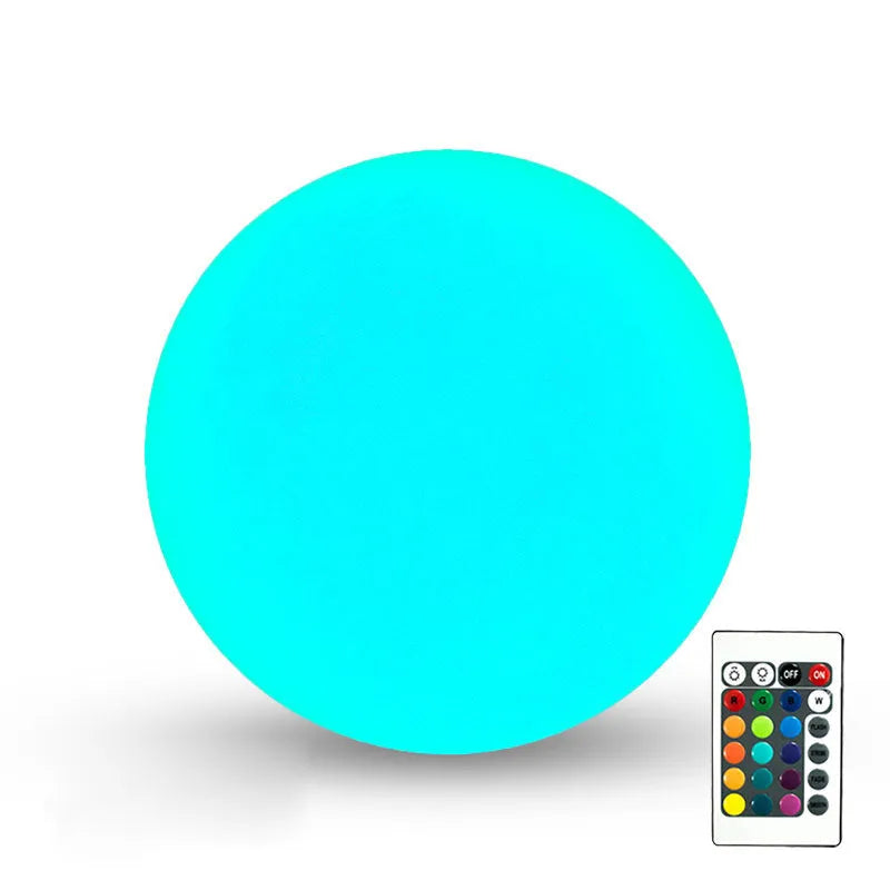 Remote-controlled LED ball lamp floating in a pool, showing multicolour light with IP67 waterproof rating.