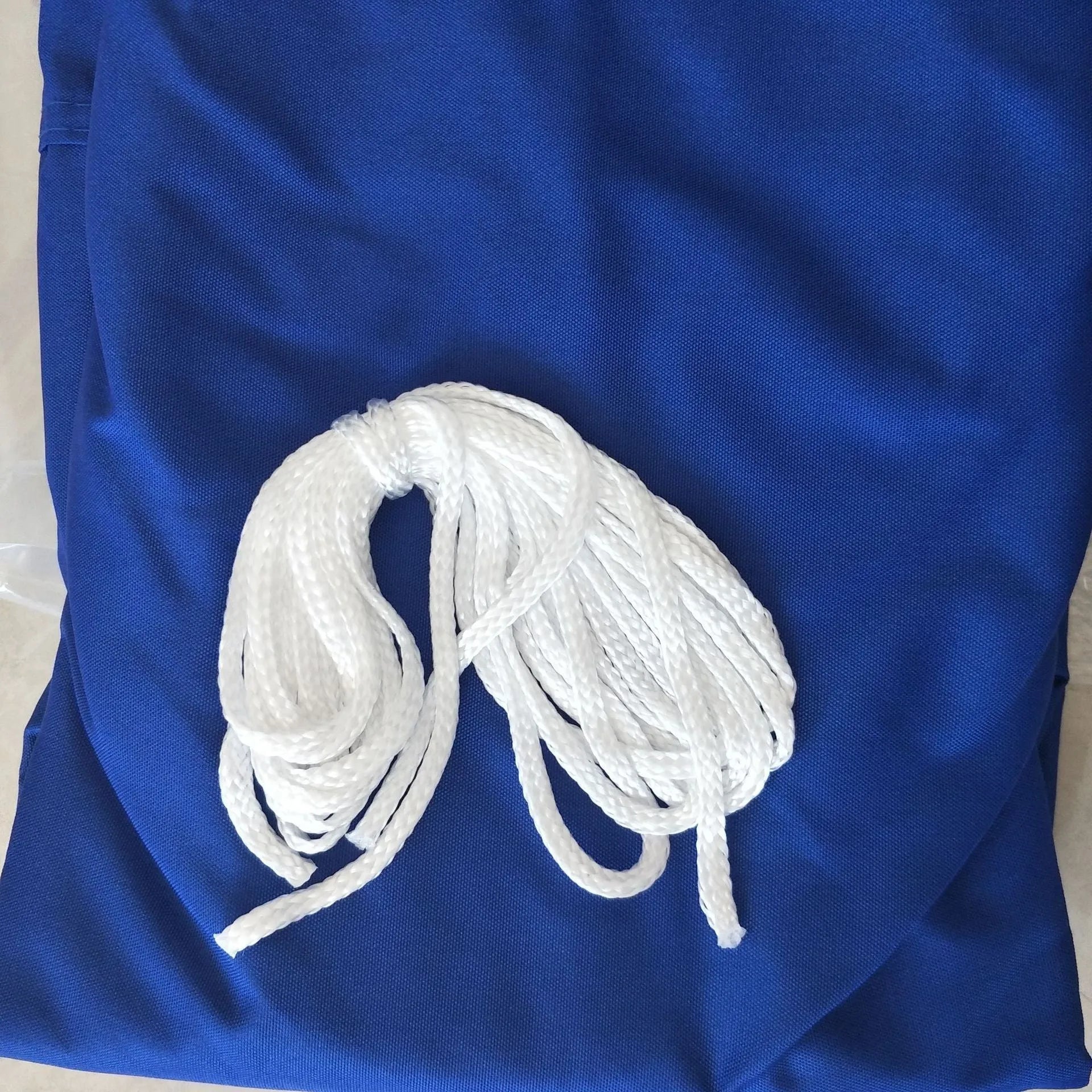 Blue curved square shade sail measuring 3x4 metres providing garden sun protection
