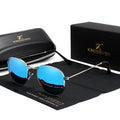 Classic round metal frame sunglasses for men in gun grey colour with UV400 lenses on a table.