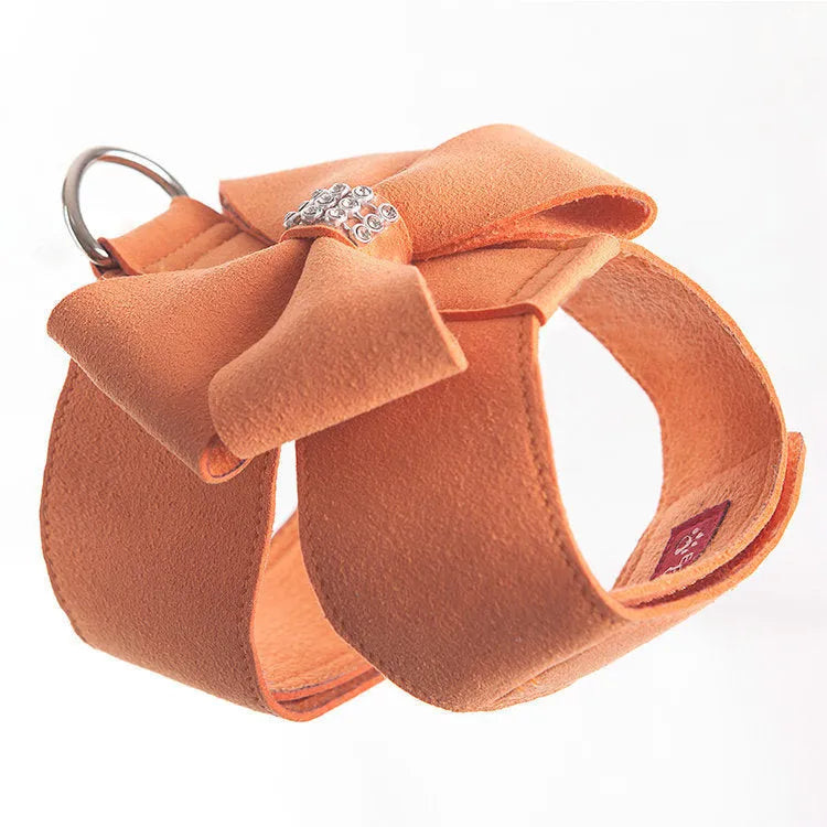 A pink microfiber dog chest strap with a decorative bow, sized for a small puppy.