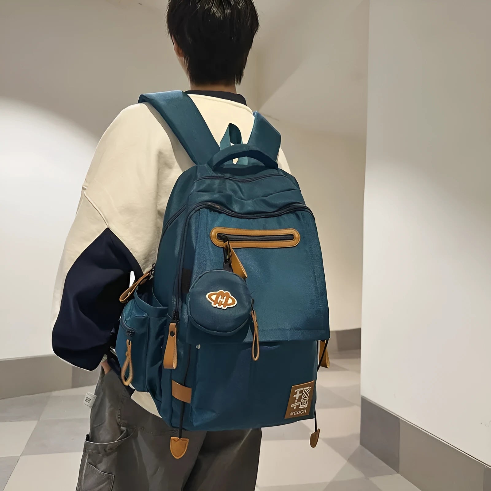 Large-capacity black nylon school backpack for junior high students with a curved shoulder strap.