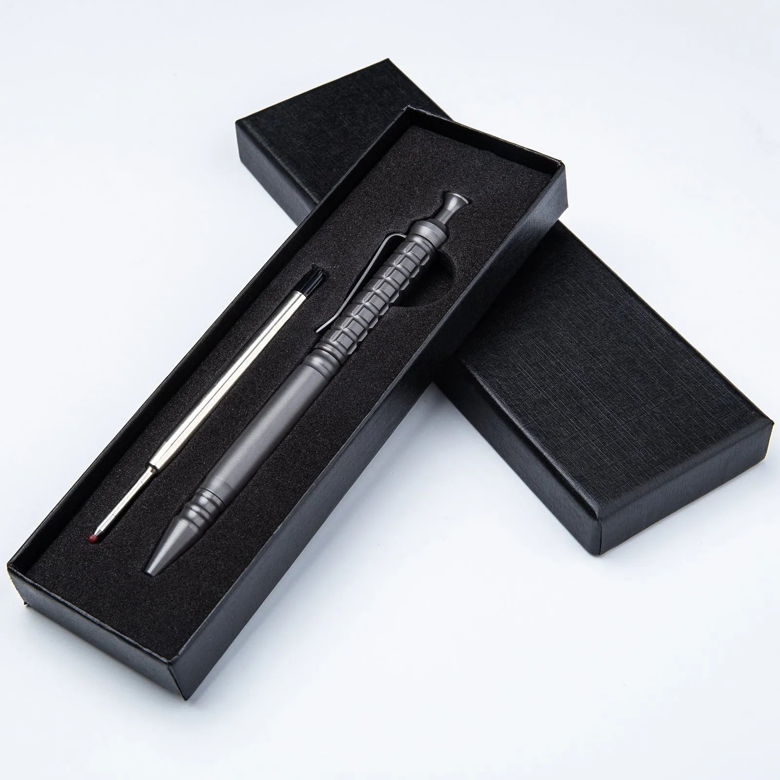 Gunmetal grey titanium alloy tactical pen with push-action decompression mechanism