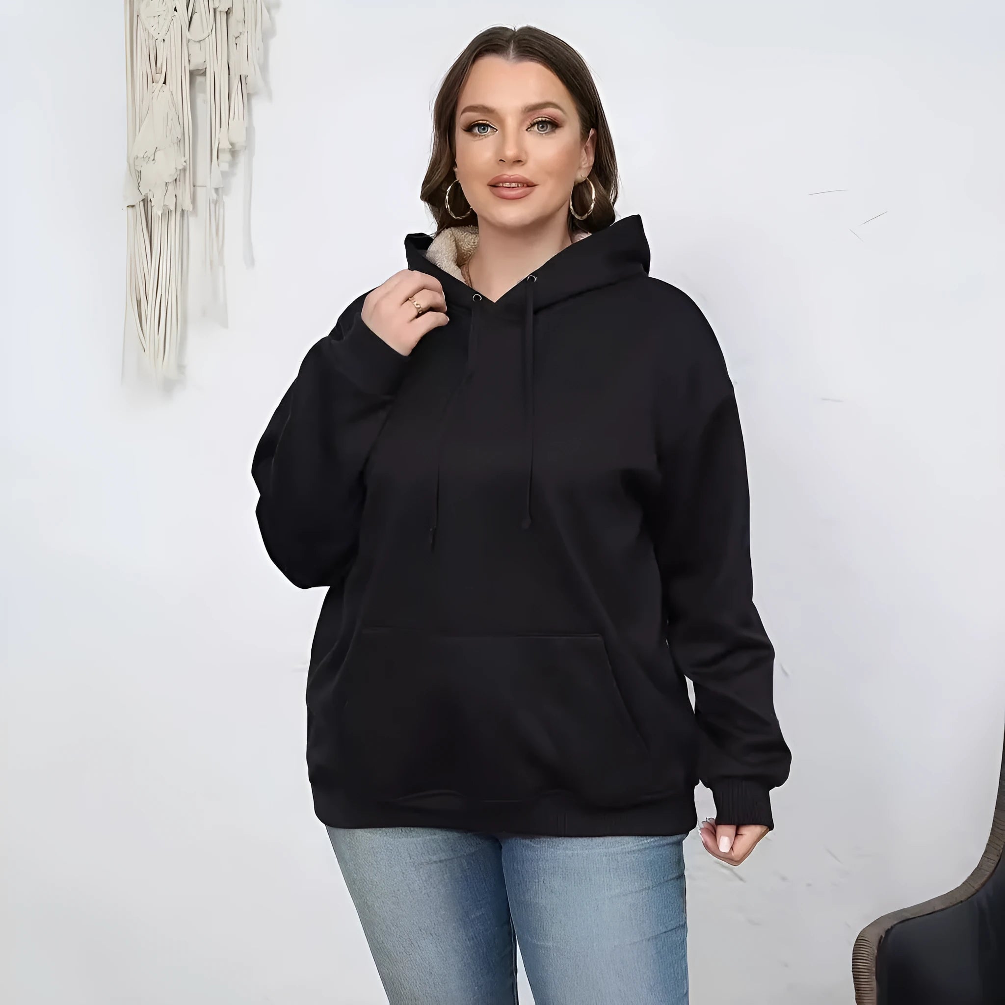 Women's loose fit hooded sweater in thick polyester fabric available in multiple colours.