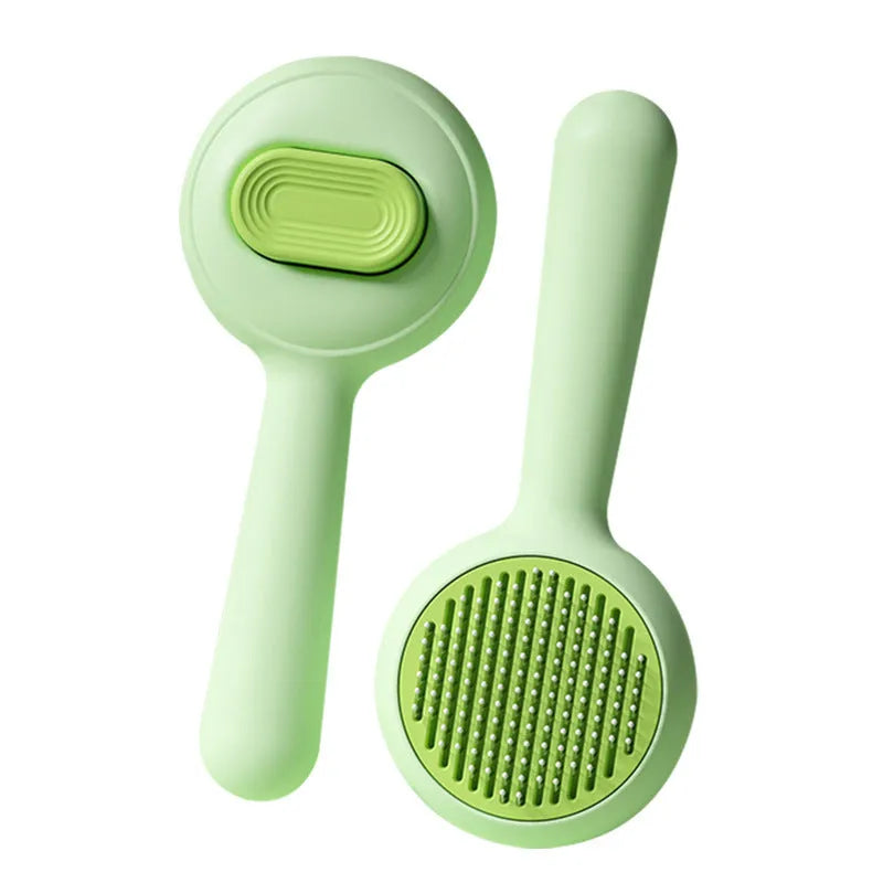 Green and yellow cat grooming brush with stainless steel pins and non-slip ergonomic handle