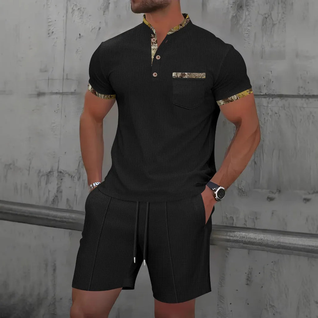 Man modelling a grey zip-front polo collar top and matching shorts, a waffle knit leisure suit set.