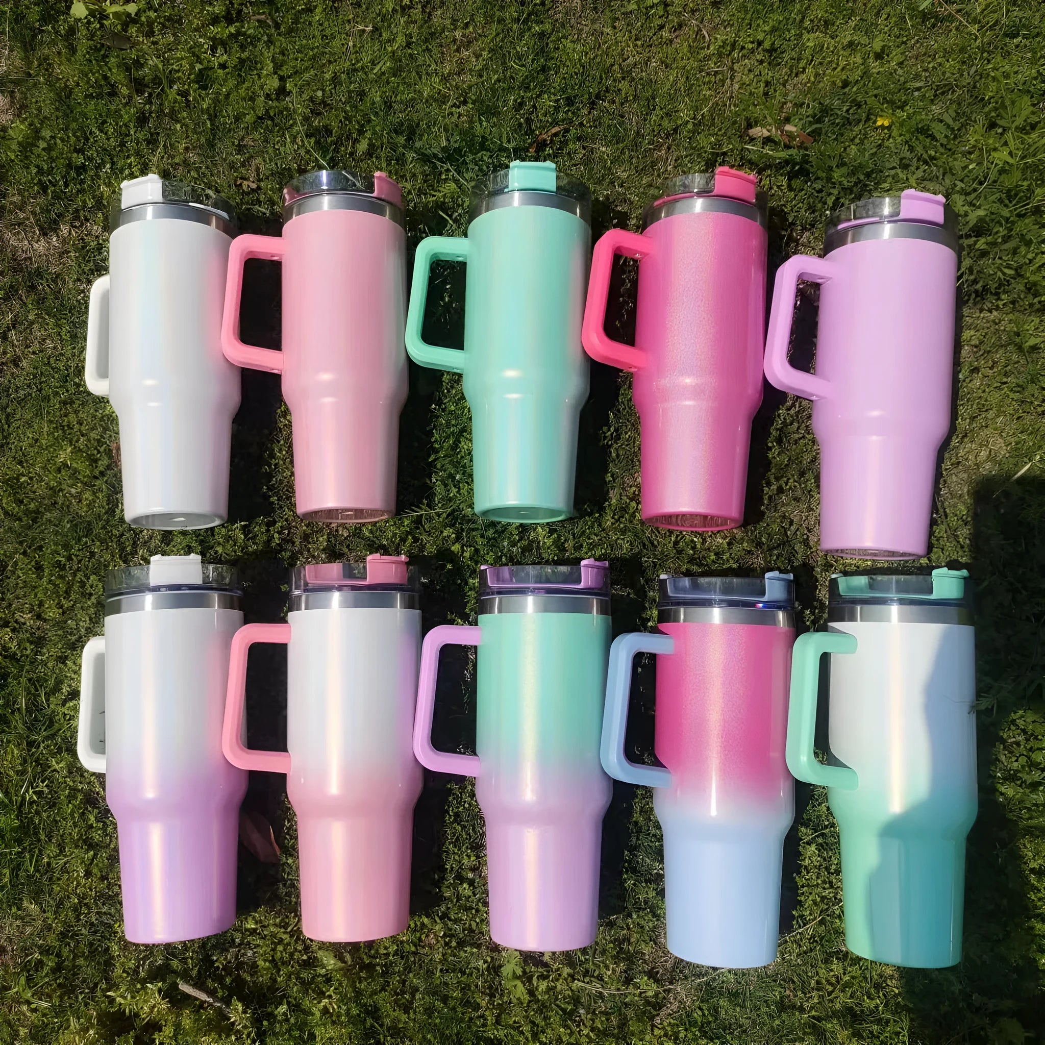 Large stainless steel vacuum insulation cup showing rainbow colour options and gradient designs