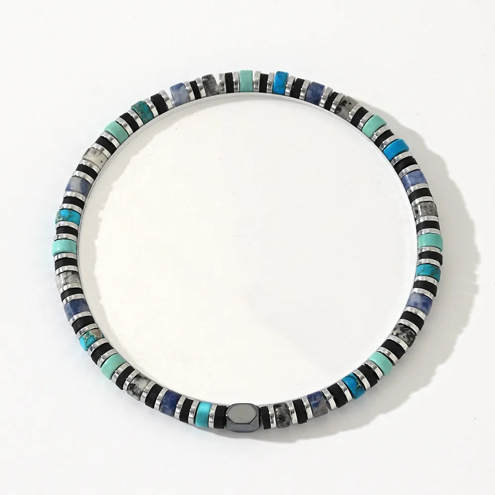 Close-up of a hand-woven cylindrical bohemian bracelet made from natural semi-precious stones in geometric patterns