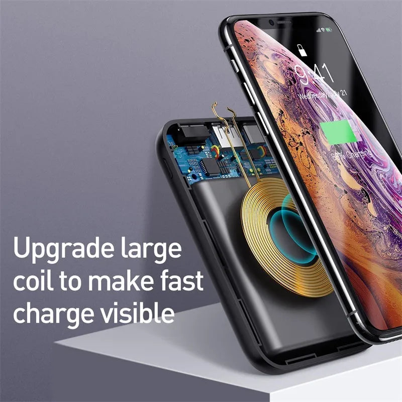 Square black wireless power bank with digital display showing battery percentage, next to a smartphone on its wireless charging surface.