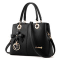 Retro style one-shoulder handbag in black with gold zipper, showing structured shape