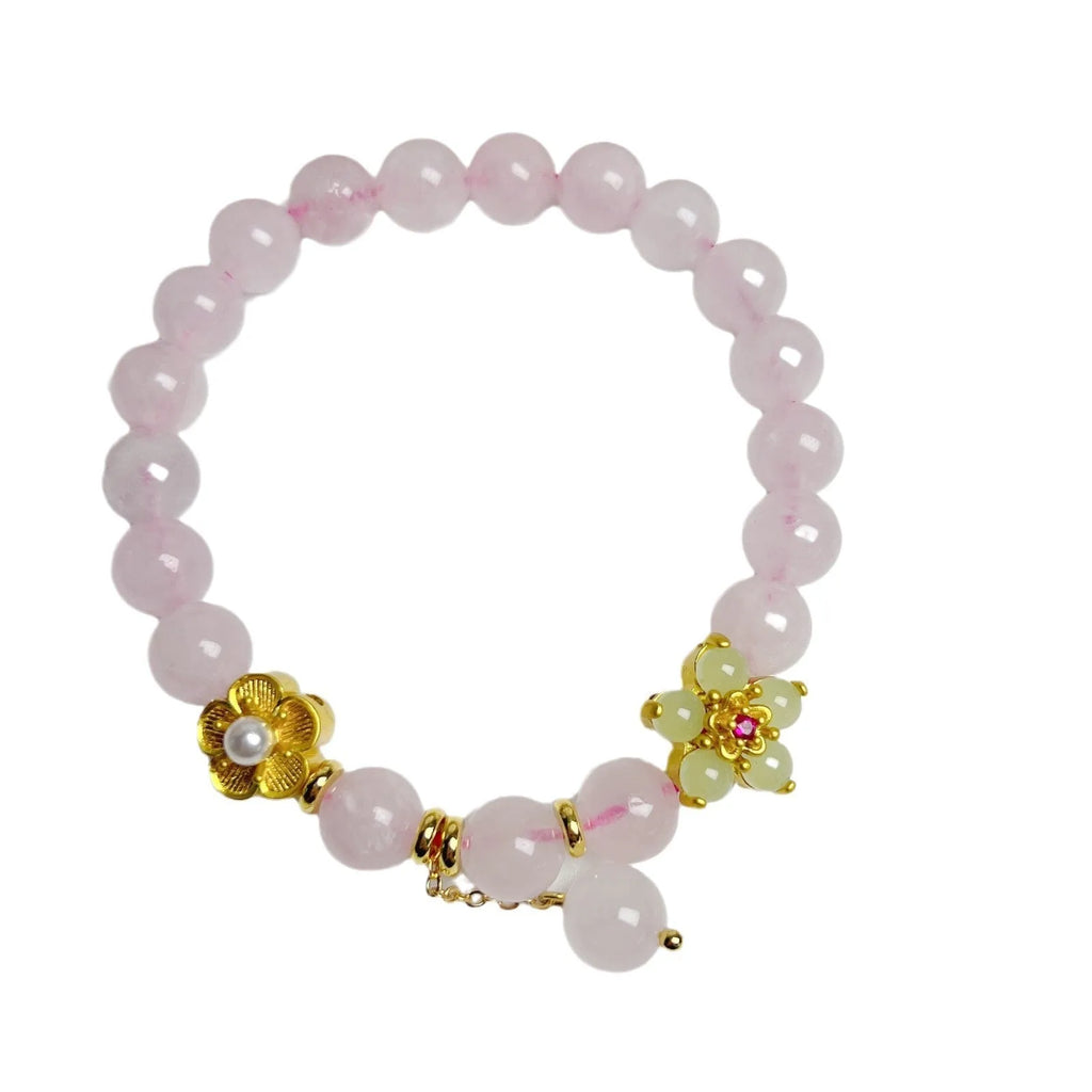 Pink crystal peach blossom bracelet with adjustable clasp on woman's wrist
