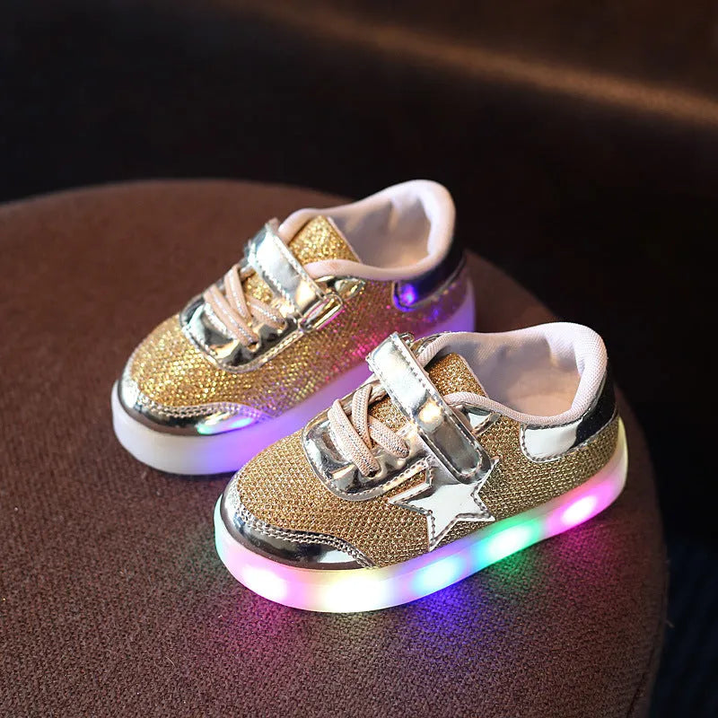 Children's LED magic button shoes with flashing lights in golden, pink, and silvery colours.