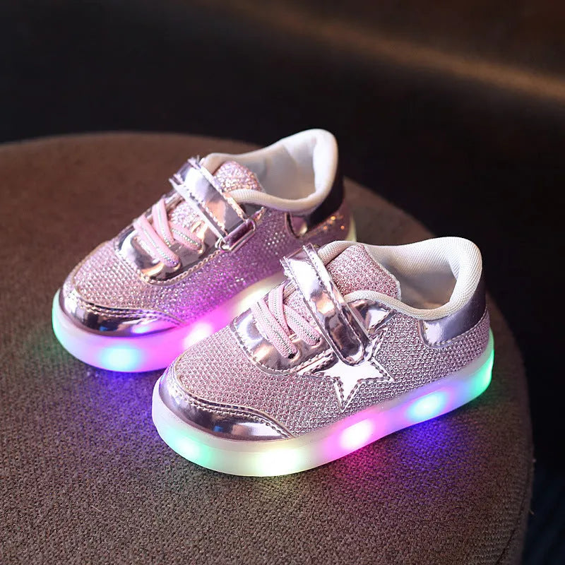 Children's LED magic button shoes with flashing lights in golden, pink, and silvery colours.
