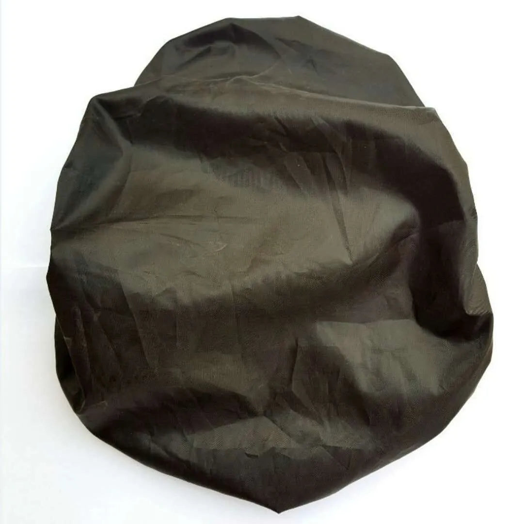 Black bicycle saddle with silicone padding and two visible steel springs underneath, shown with a waterproof cover and tools.
