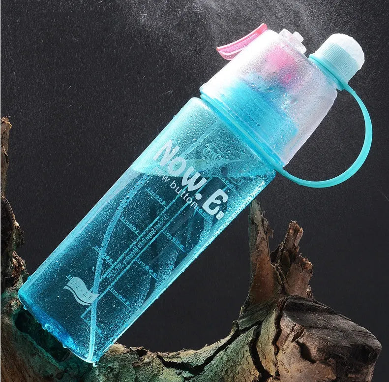 Green portable sports mist spray cup with transparent body, volume scale, handle, and spray mouth.
