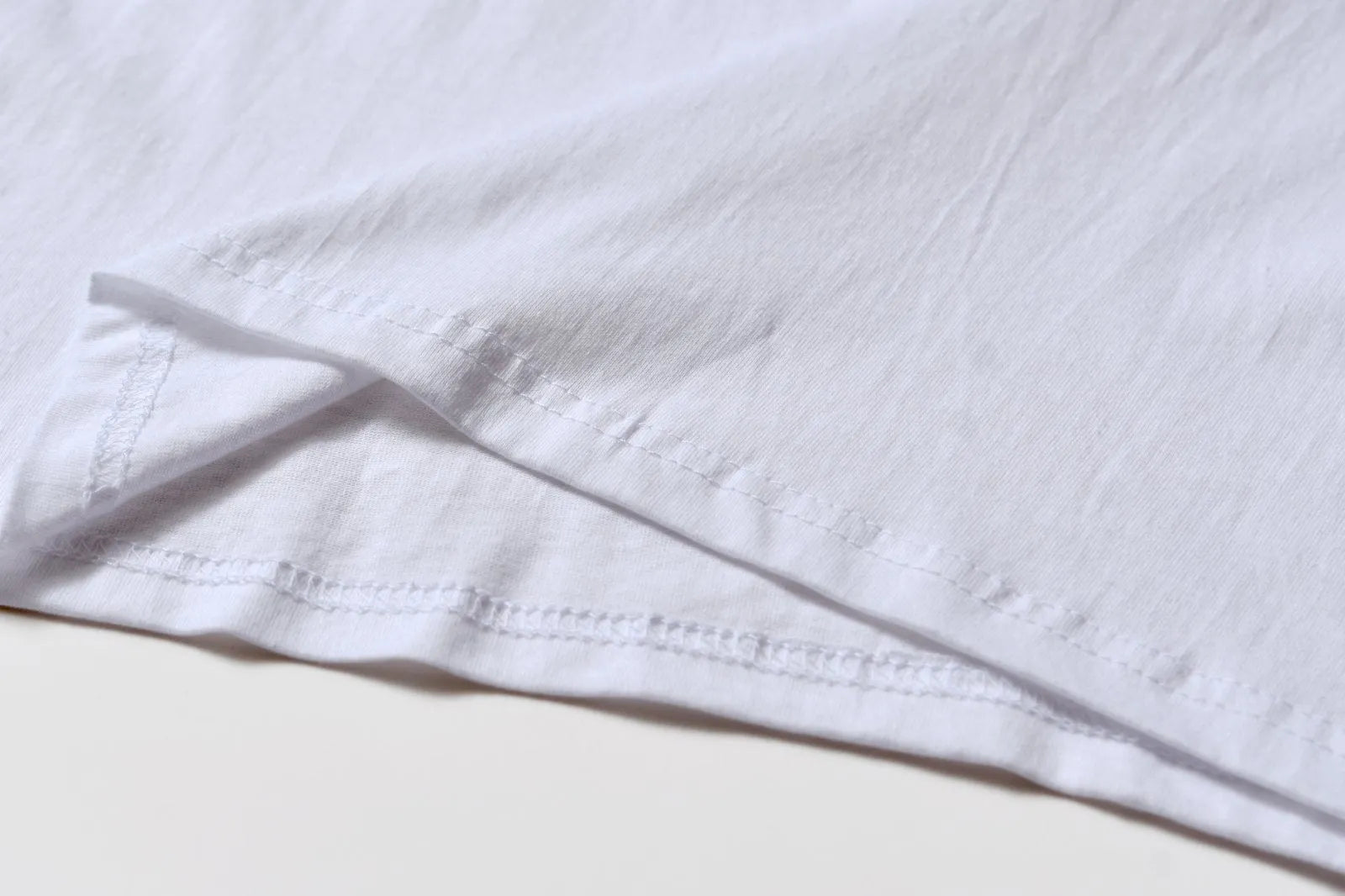 White cotton t-shirt overalls with short sleeves and a loose pullover fit