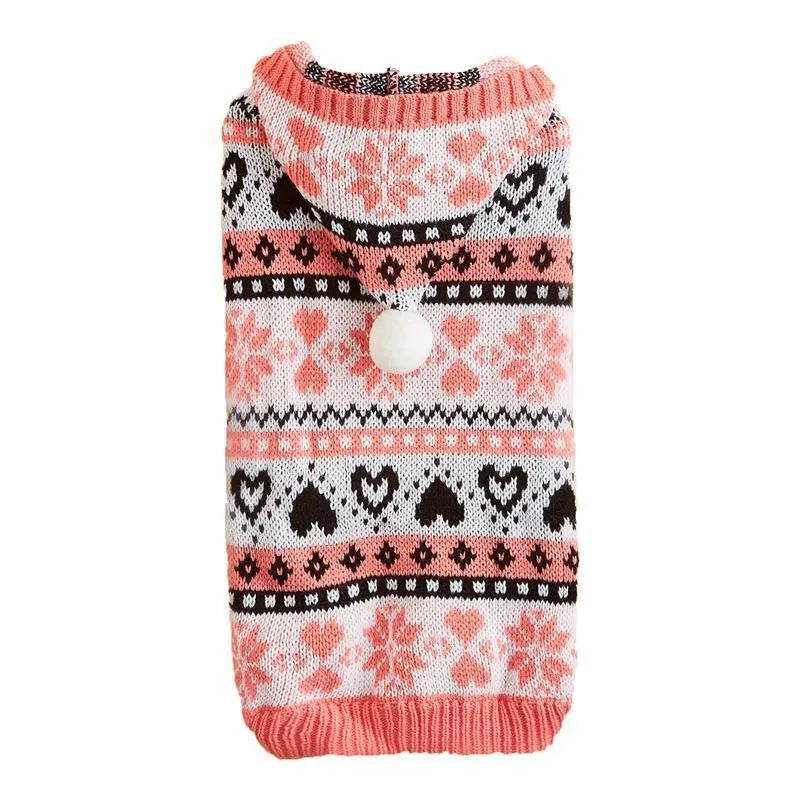 Blue knitted dog sweater with white snowflake and love heart patterns on a striped camouflage background.