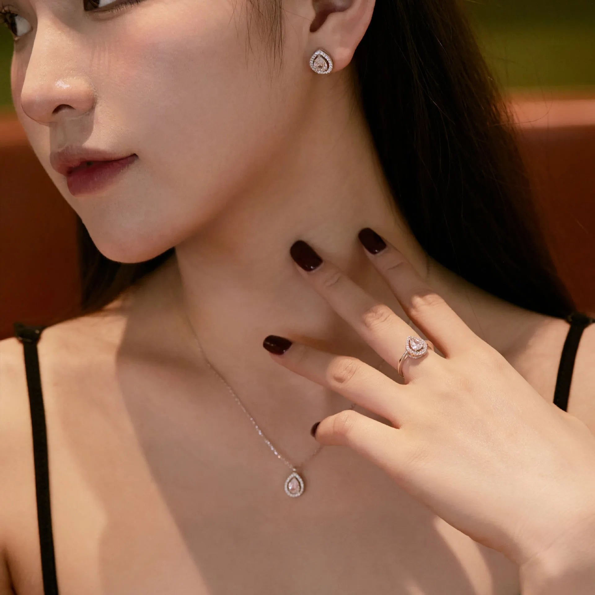 S925 sterling silver ring with drop-shaped diamond zircon stone in light luxury style on a plain background