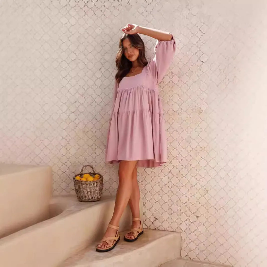 Orange red children's backless pullover dress with puff sleeves and a square collar on a mannequin.