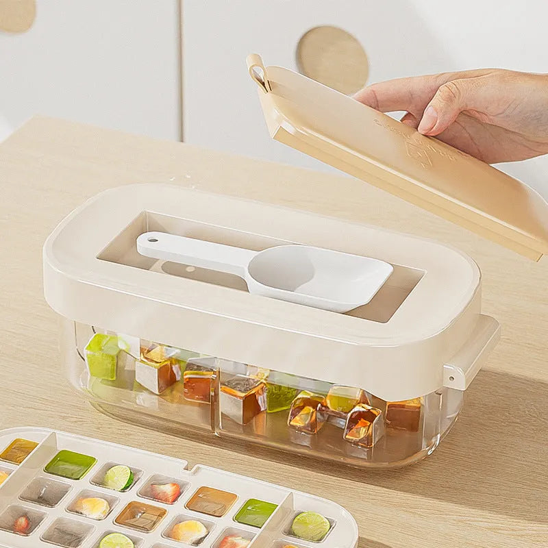 A blue high-capacity ice cube tray with a lever mechanism for easy demoulding and a stored ice shovel.