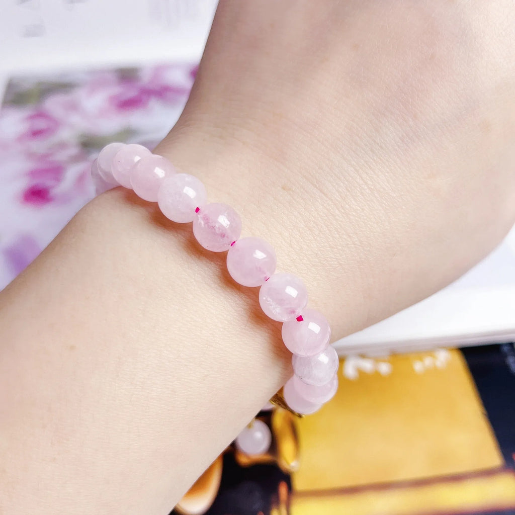Pink crystal peach blossom bracelet with adjustable clasp on woman's wrist