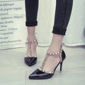 Studded pointed high heels with stiletto heel and buckle fastening in black