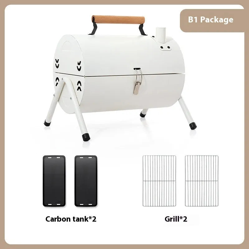 White portable charcoal barbecue grill with chimney oven, folded legs, two grill meshes, and detachable fuel tanks on a wooden table.