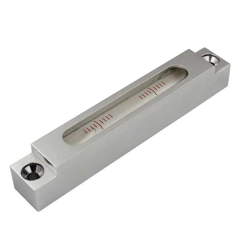 Metal and glass mini strip level showing precision vial on a 132mm long ruler.
