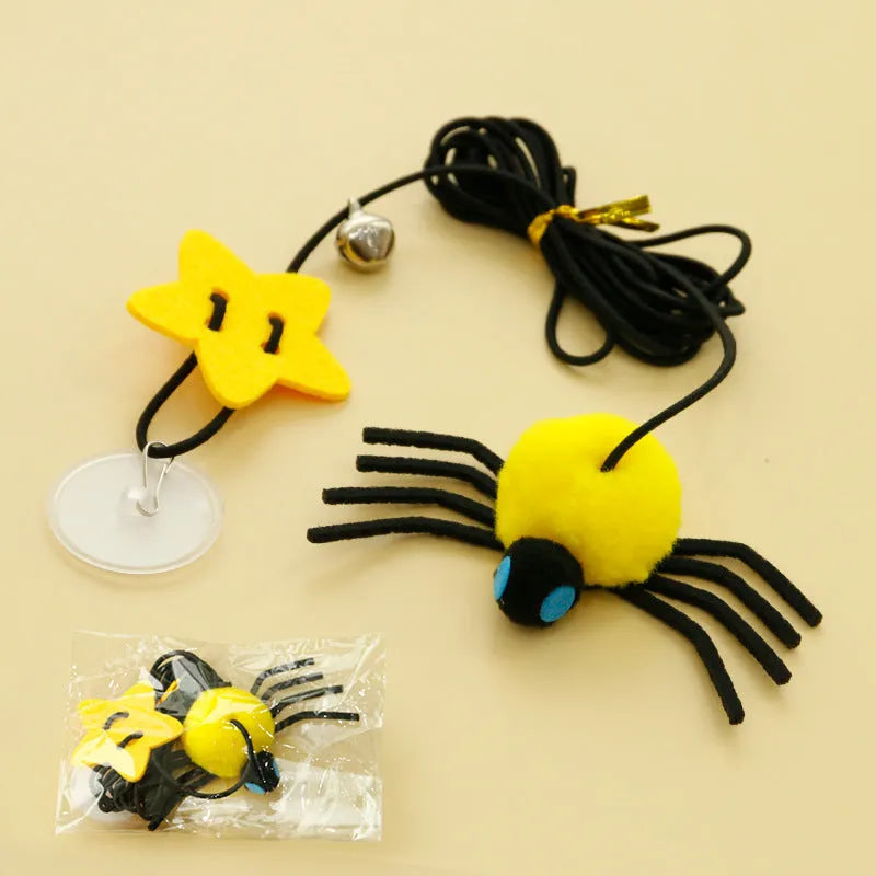 Red hanging cat toy with elastic rope, feathers, and bell spider ornament mounted on door