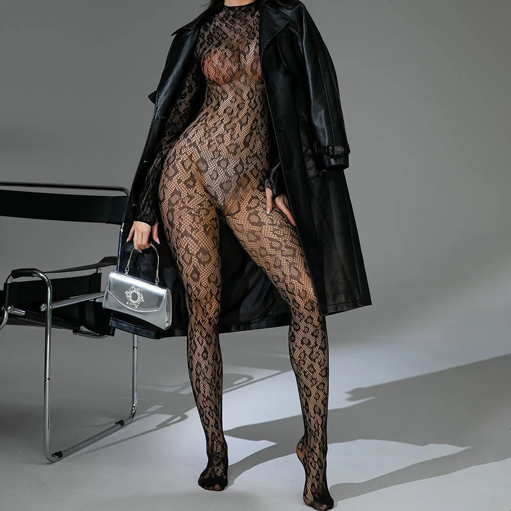 Black long sleeve backless fishnet lingerie bodysuit with jacquard detail laid flat.