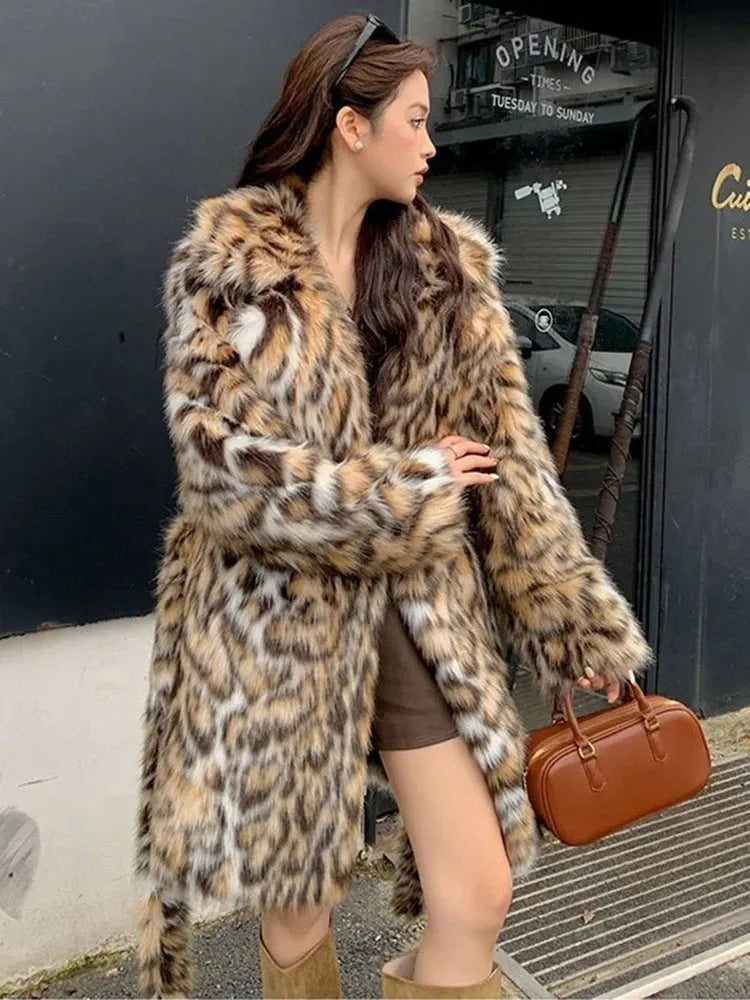 Long grey faux fur coat with a detachable fur collar and pockets on a model.