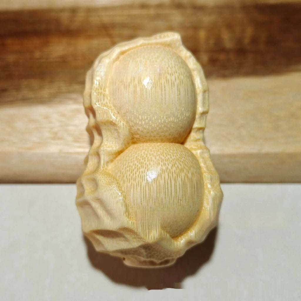 Solid bamboo carving peanut ornament on natural background