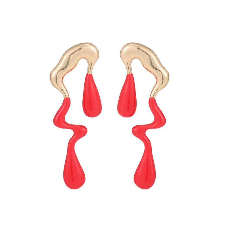 A pair of liquid irregular geometric water drop ear studs in gold finish on a neutral background