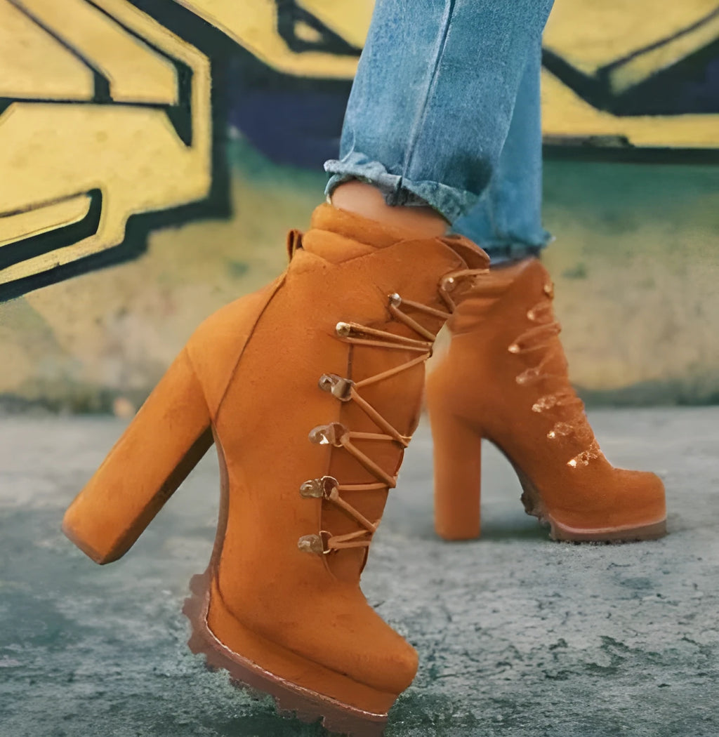Women's army green suede Roman boots with high thick heels, a platform sole, and decorative rivets.