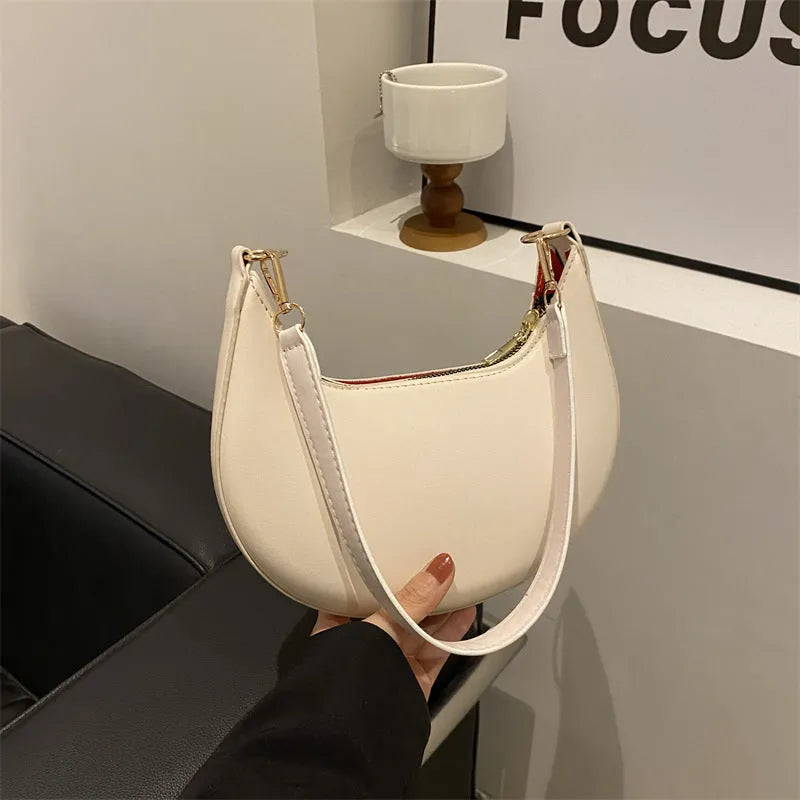 Round green one-shoulder underarm bag with visible sewing lines and sandwich-style compartments