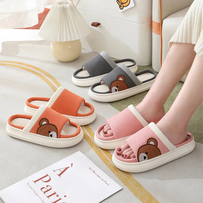 Pair of women's cartoon bear slippers with cotton linen upper and non-slip PVC sole, in light brown colour