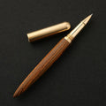 Brass and solid wood signature pen showing wood grain and metallic details.