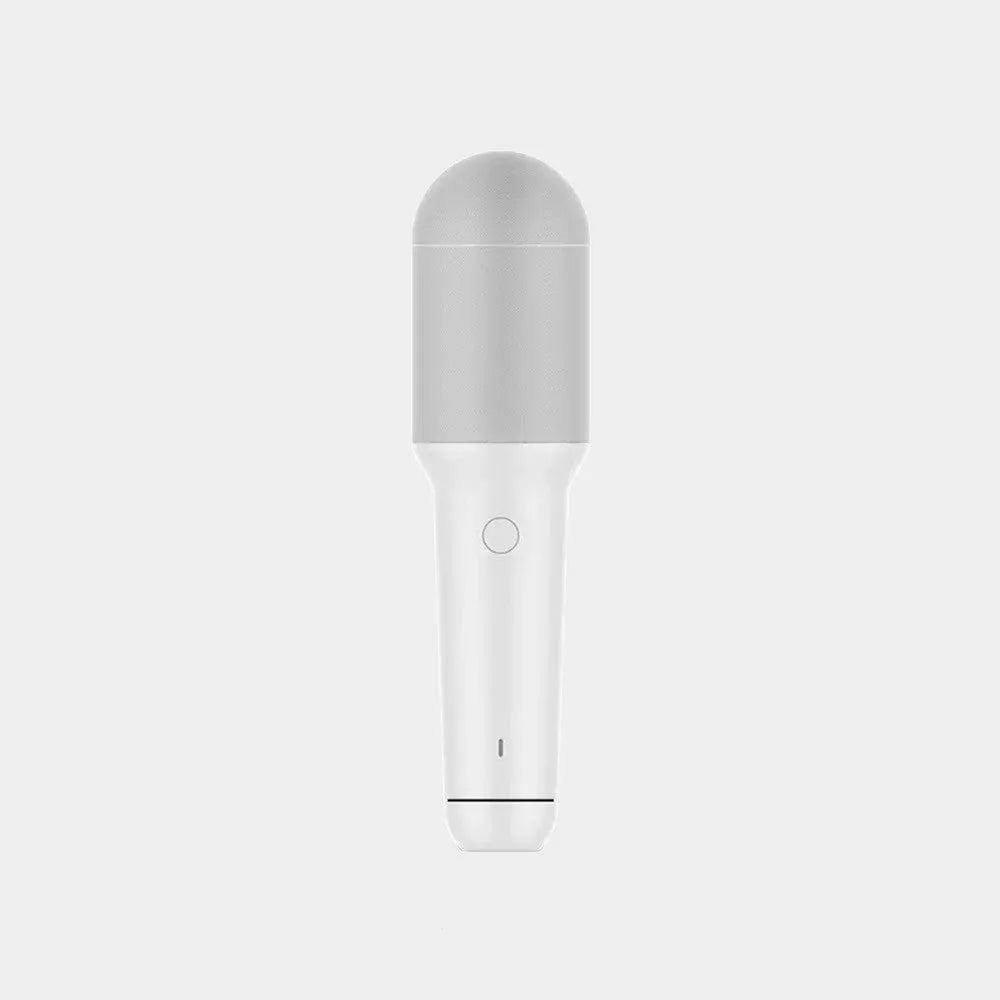 White wireless karaoke microphone with built-in speaker and metal mesh grille on a plain background