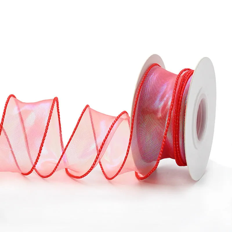 Roll of colourful wave patterned fishtail yarn decorative ribbon in mesh material, 4cm wide.