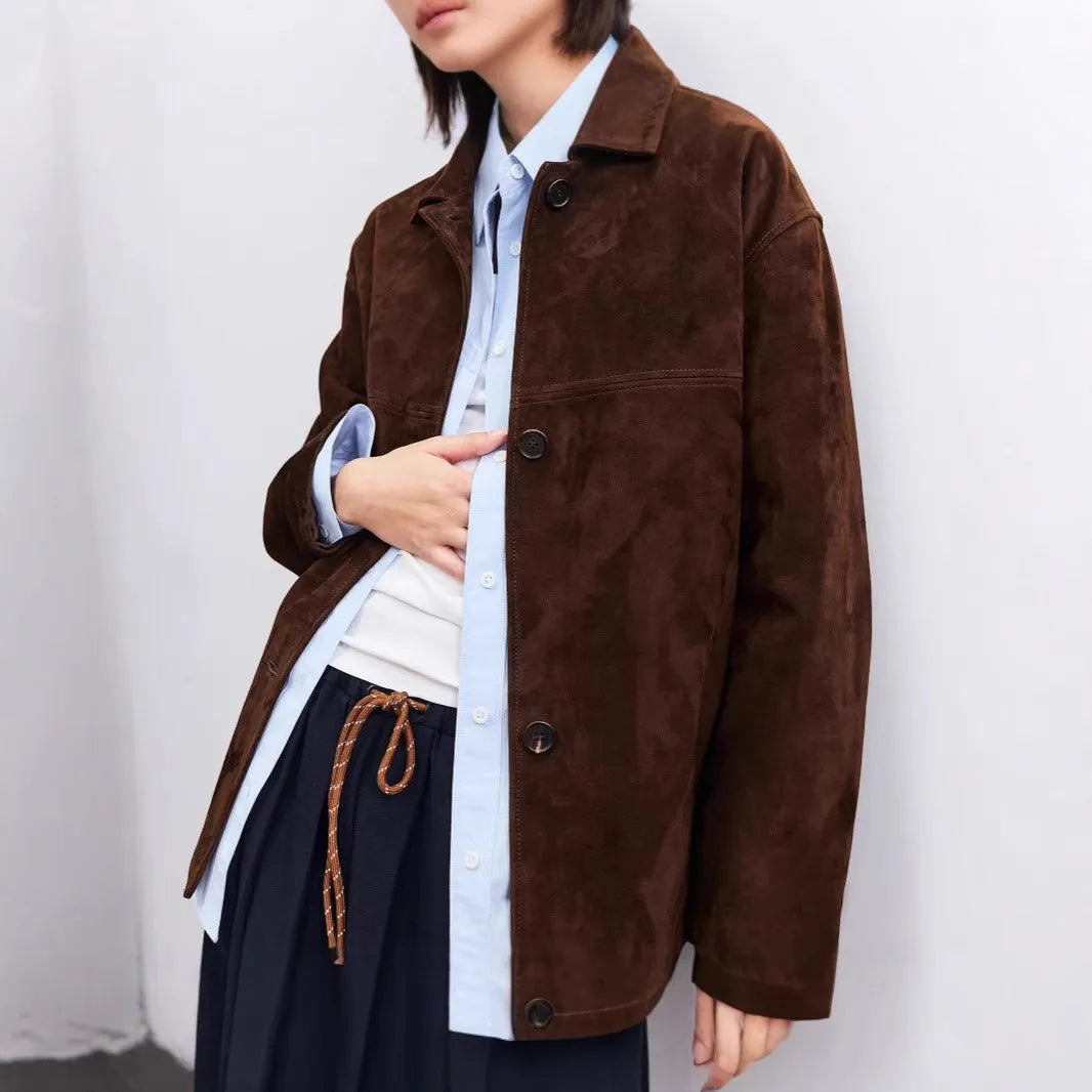 Yellow Brown retro cashmere coat with Peter Pan collar and leather stitching on a hanger.