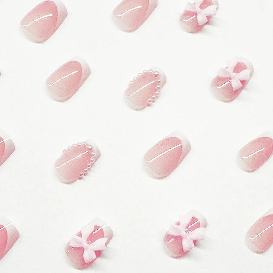 Set of 24 short, square false nails with pre-designed bow, tulip, starry sky, and leopard print patterns for a French manicure.