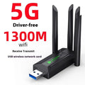 Black USB network transmitter with four external antennae for computer Wi-Fi signal boosting.