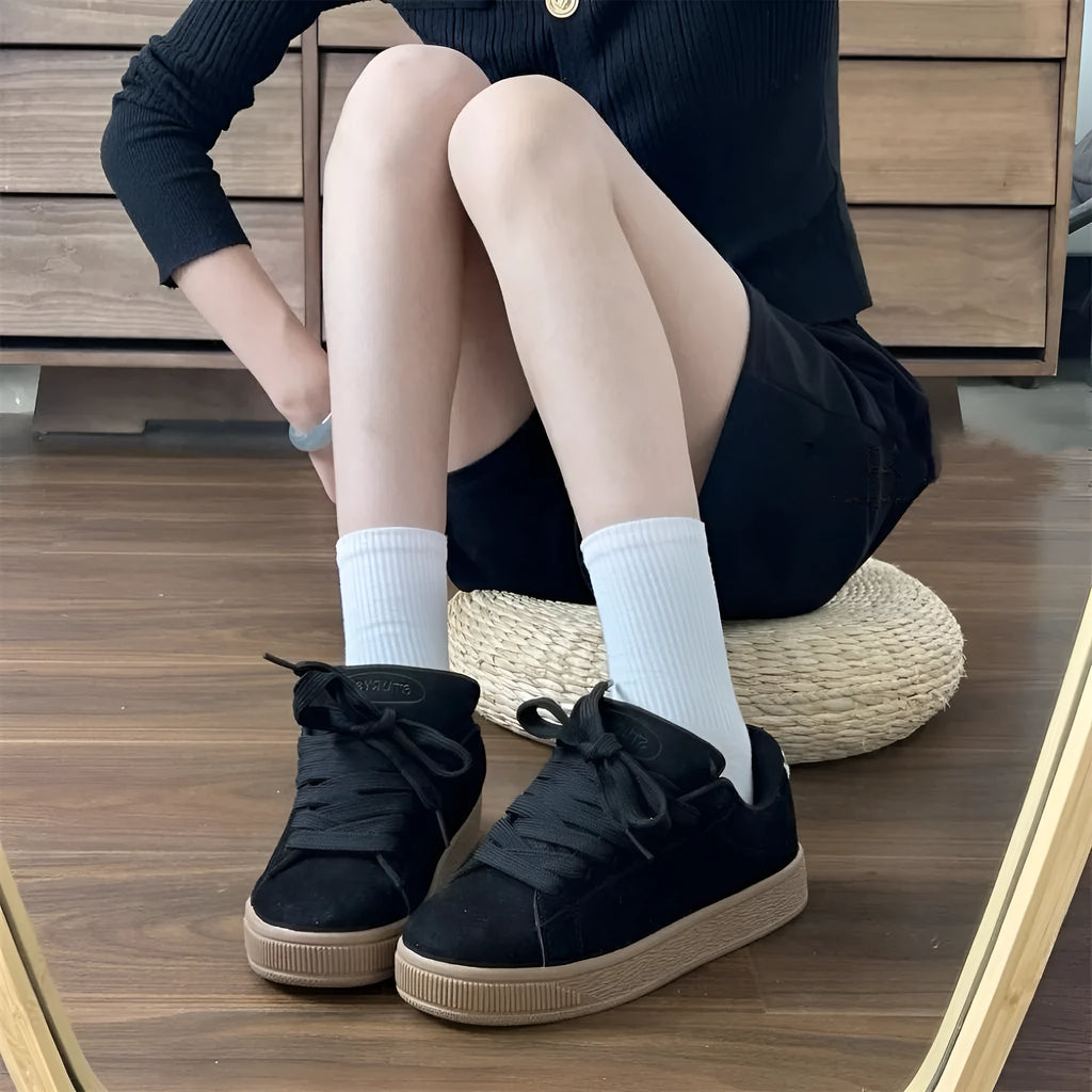 Black retro low-top sneakers with waterproof platform sole and round toe design