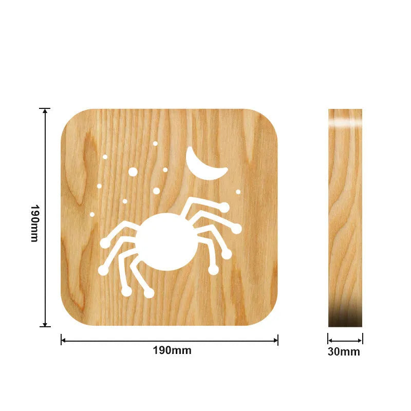 Halloween spider creative light made from pine wood with warm white glow on a wooden table