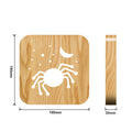Halloween spider creative light made from pine wood with warm white glow on a wooden table