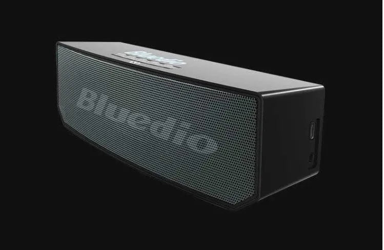 Black cloud smart speaker with compact design and micro-USB port.