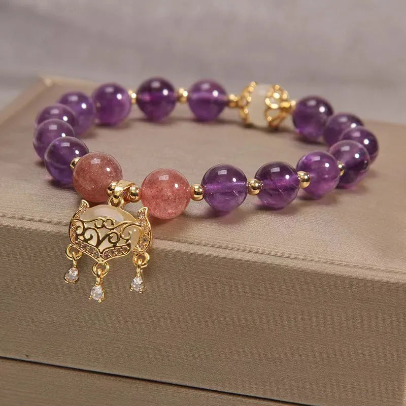 Handmade copper women's bracelet with a drop-shaped real gold longevity lock charm and natural amethyst accents.