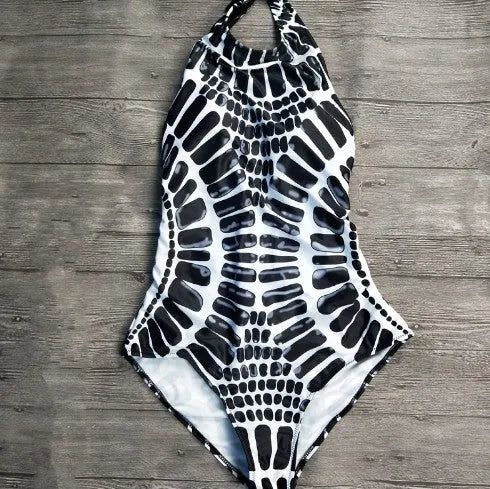 Backless one-piece swimsuit with printed striped pattern, shown in a women's swimming costume style, sizes S to XXL.