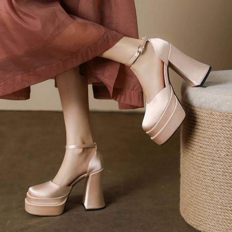 Women's white platform high heels with a chunky heel and round toe on a plain background.