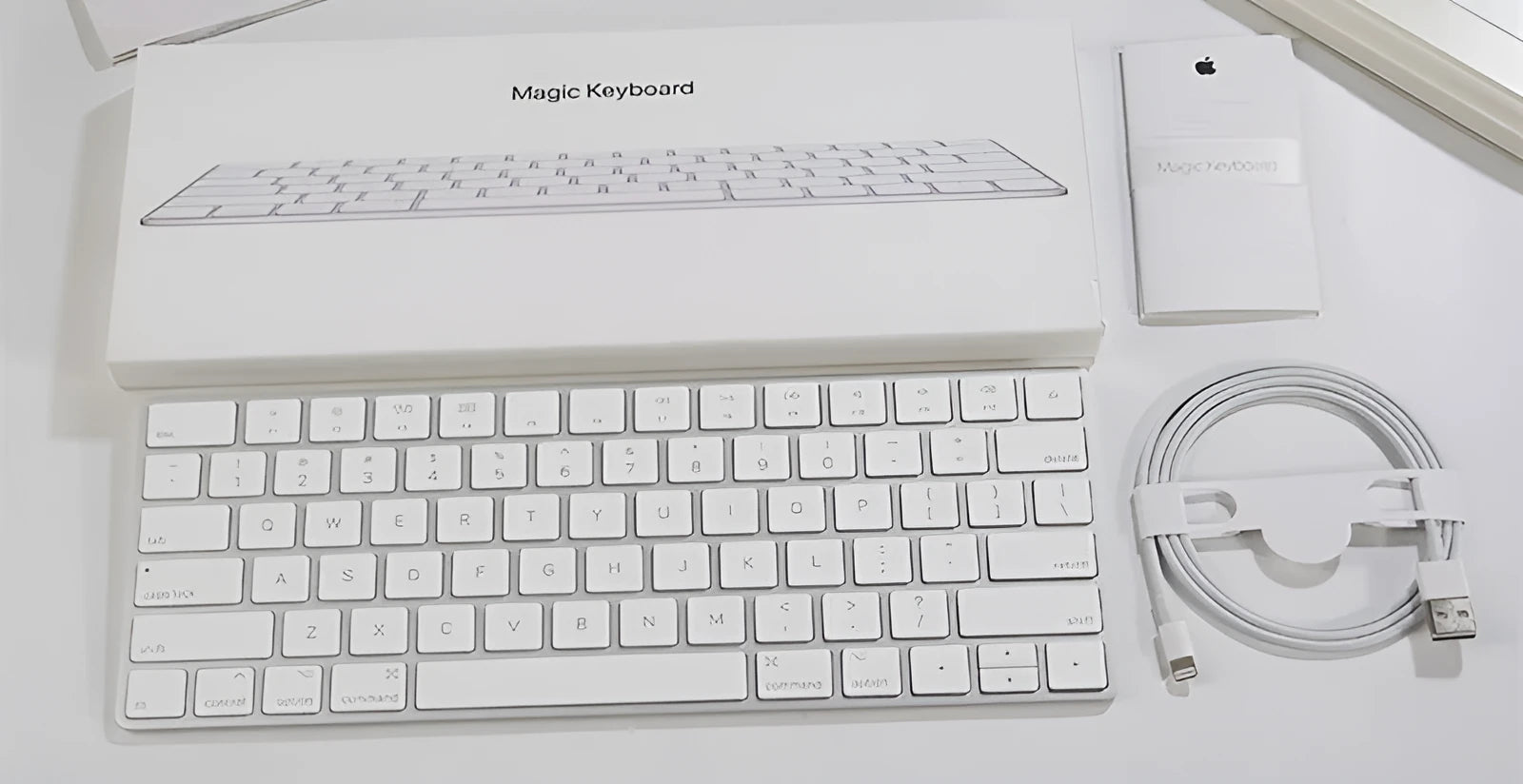 White Apple G6 Bluetooth wireless keyboard with ultra-thin metal design on desk