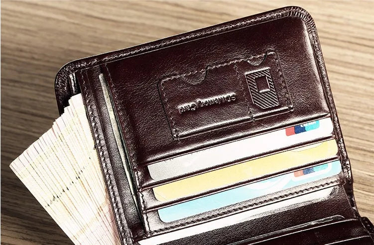 Men's black leather bifold wallet open, showing eight card slots, bill compartment, and a zip coin pocket